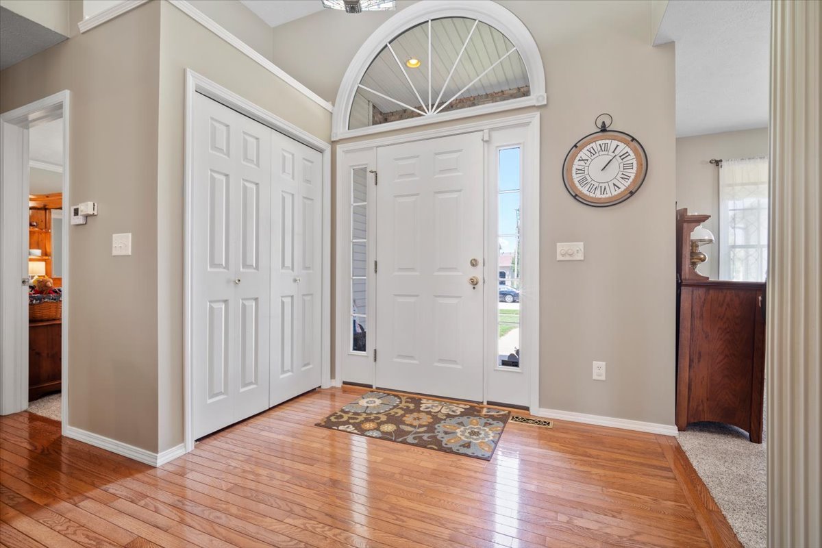 3205 Stonebridge Drive Bloomington, IL 61704 - Photo 3 of 37 a view of a hallway with wooden floor