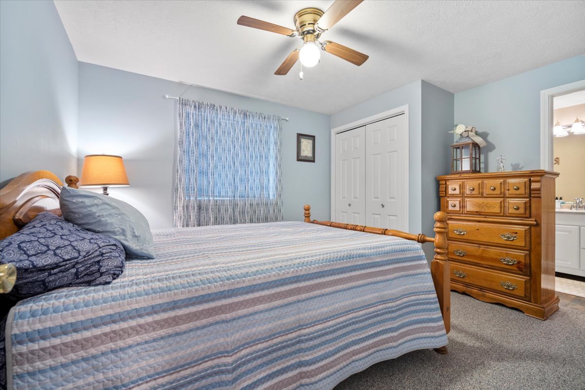 3205 Stonebridge Drive Bloomington, IL 61704 - Photo 31 of 37 a bedroom with a bed and a chandelier