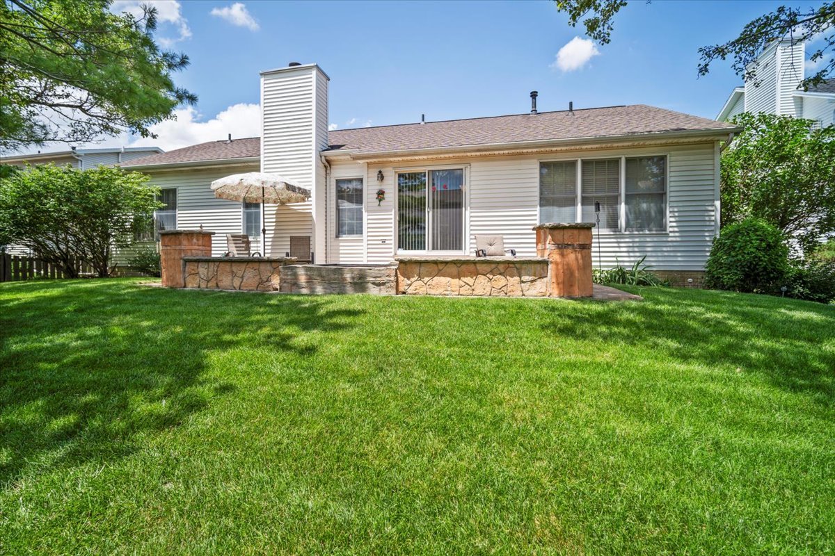 3205 Stonebridge Drive Bloomington, IL 61704 - Photo 34 of 37 a front view of a house with a garden and yard