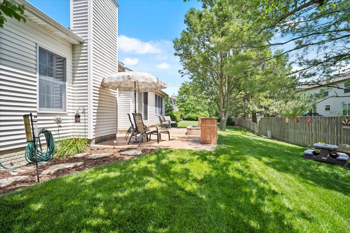 3205 Stonebridge Drive Bloomington, IL 61704 - Photo 35 of 37 a view of a chair and table in backyard of the house