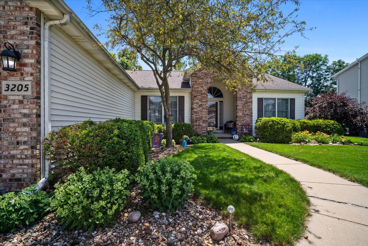 3205 Stonebridge Drive Bloomington, IL 61704 - Photo 36 of 37 a front view of a house with a garden
