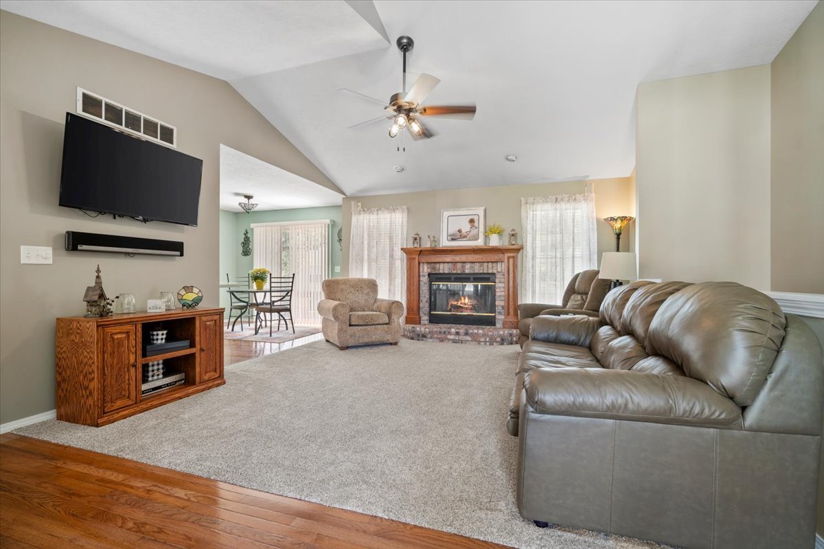 3205 Stonebridge Drive Bloomington, IL 61704 - Photo 5 of 37 a living room with furniture a flat screen tv and a fireplace