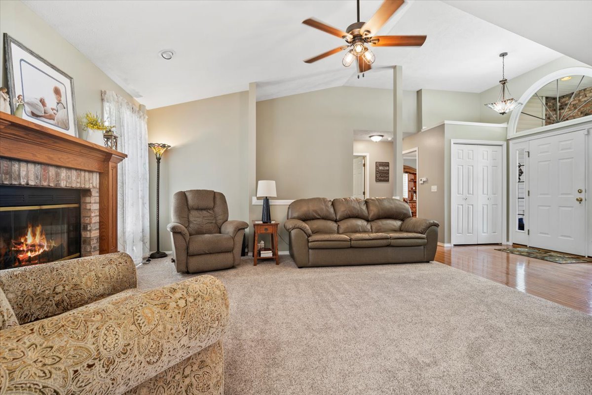 3205 Stonebridge Drive Bloomington, IL 61704 - Photo 6 of 37 a living room with furniture and a fireplace