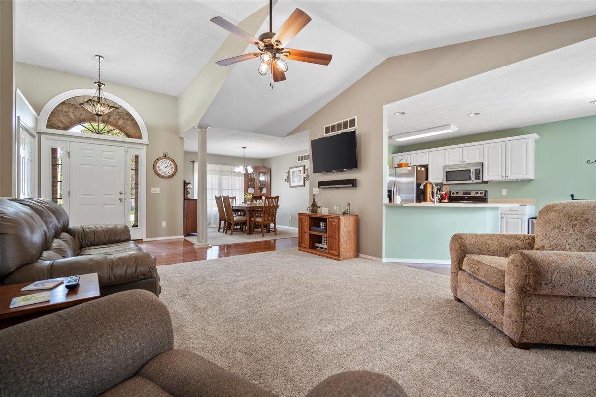 3205 Stonebridge Drive Bloomington, IL 61704 - Photo 7 of 37 a living room with furniture kitchen view and a chandelier