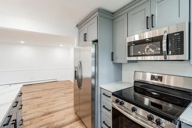 a kitchen with a stove and a refrigerator