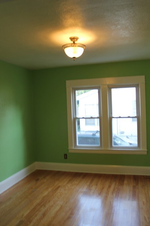 18-20 Howes Street Springfield, MA 01118 - Photo 11 of 30 an empty room with wooden floor and windows