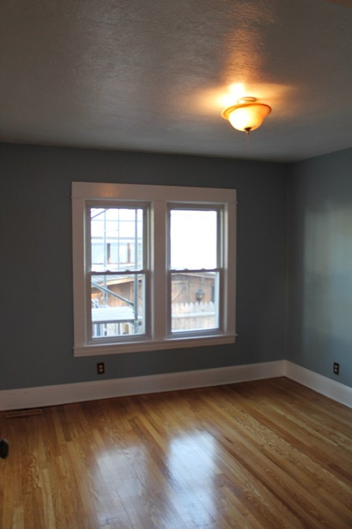 18-20 Howes Street Springfield, MA 01118 - Photo 12 of 30 a view of a livingroom with wooden floor and a window