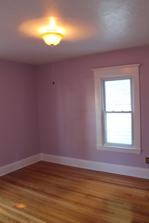 18-20 Howes Street Springfield, MA 01118 - Photo 13 of 30 a view of empty room with window and wooden floor