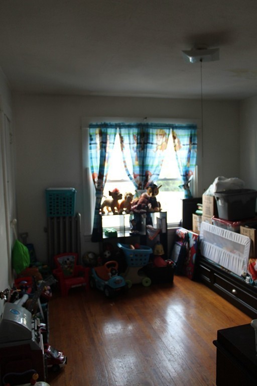 18-20 Howes Street Springfield, MA 01118 - Photo 17 of 30 a living room with furniture window and a fireplace