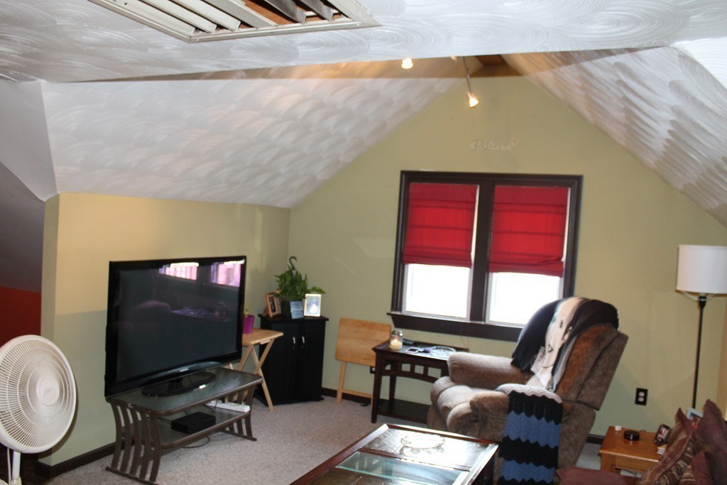 18-20 Howes Street Springfield, MA 01118 - Photo 21 of 30 a work room with furniture and a flat screen tv