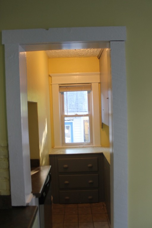 18-20 Howes Street Springfield, MA 01118 - Photo 7 of 30 a room that has a window and a chair