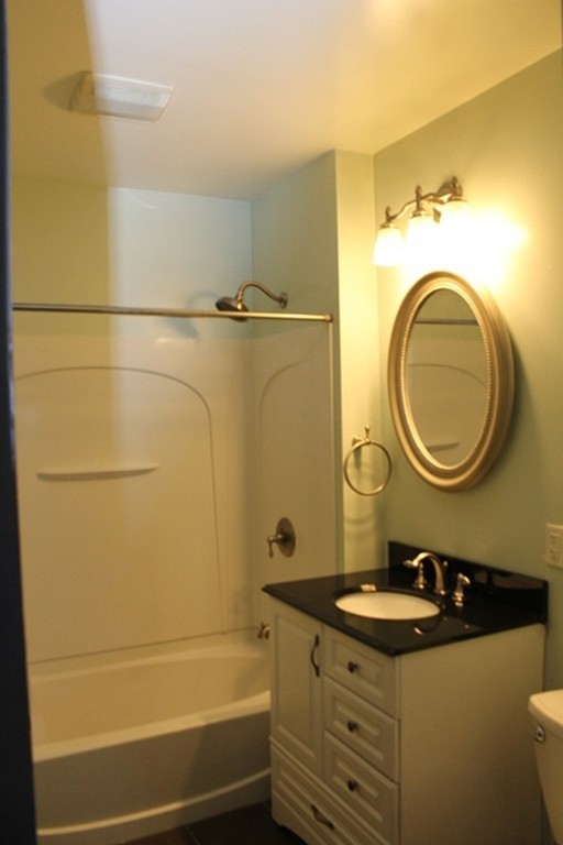 18-20 Howes Street Springfield, MA 01118 - Photo 8 of 30 a bathroom with a sink a toilet and a mirror