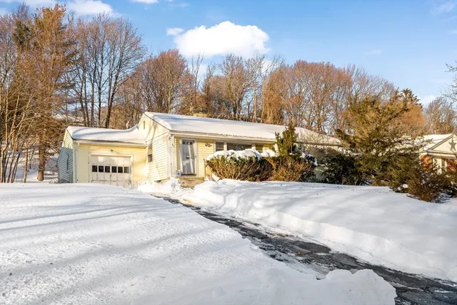 a view of a house with trees in the background
