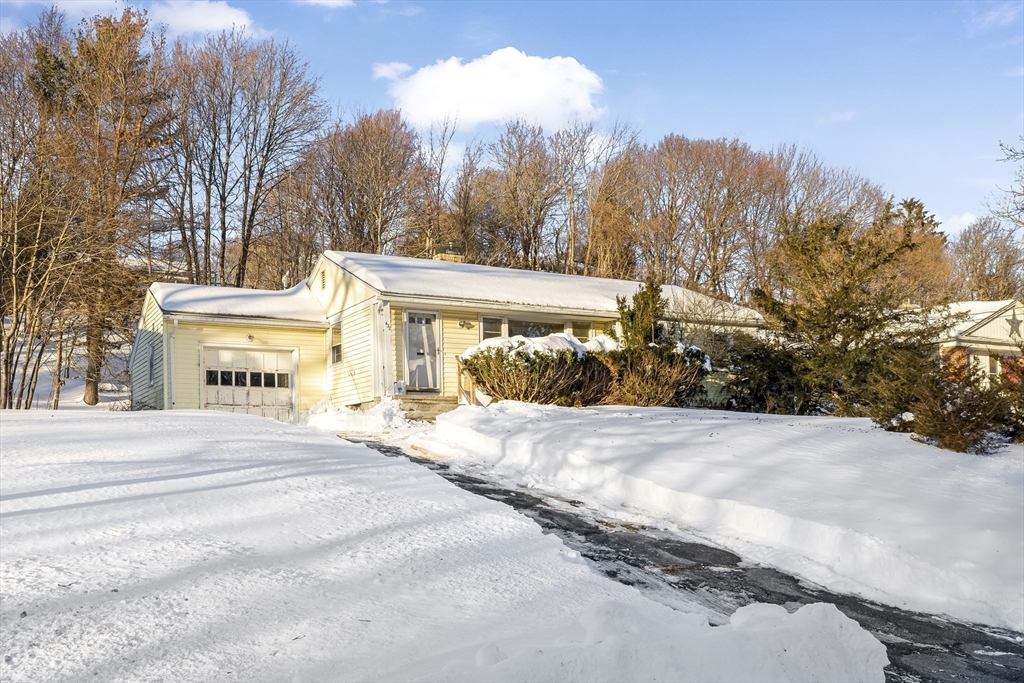 a view of a house with trees in the background