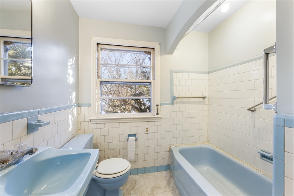 432 Mower Street Worcester, MA 01602 - Photo 13 of 16 a bathroom with a sink a toilet and shower