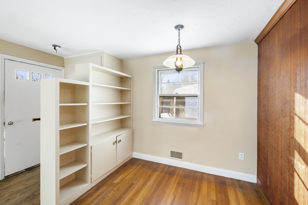 432 Mower Street Worcester, MA 01602 - Photo 4 of 16 a view of an empty room with a window and wooden floor