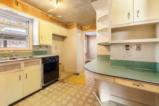 a kitchen with stainless steel appliances granite countertop a sink and a stove
