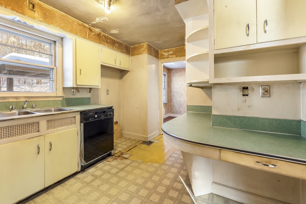 432 Mower Street Worcester, MA 01602 - Photo 6 of 16 a kitchen with stainless steel appliances granite countertop a sink and a stove