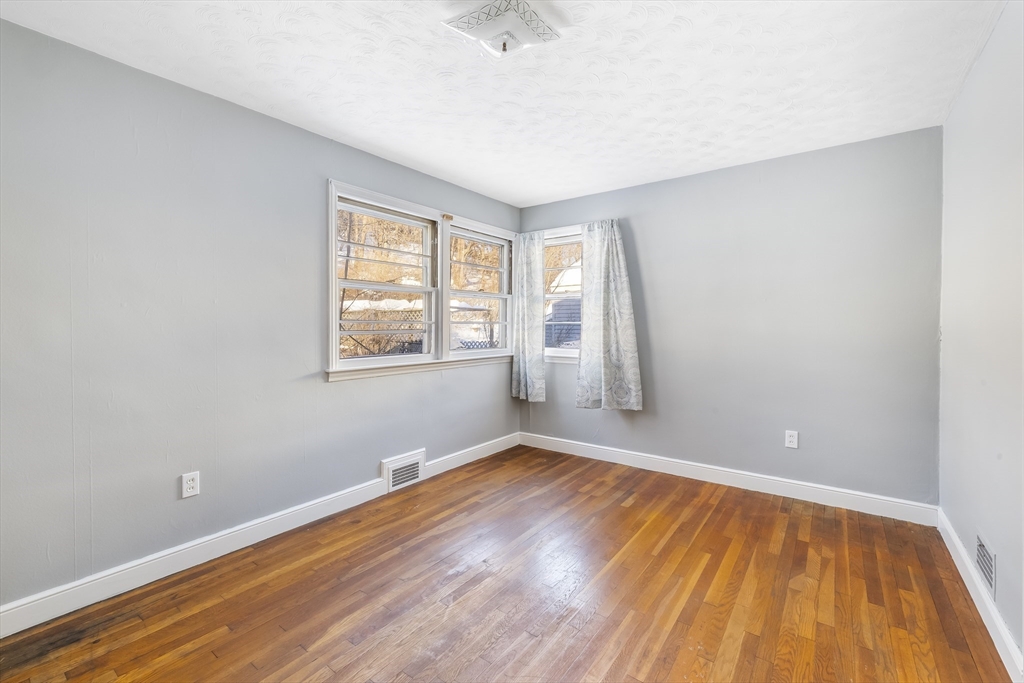 432 Mower Street Worcester, MA 01602 - Photo 10 of 16 an empty room with wooden floor and windows