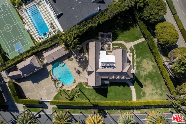 an aerial view of a house a yard and outdoor seating