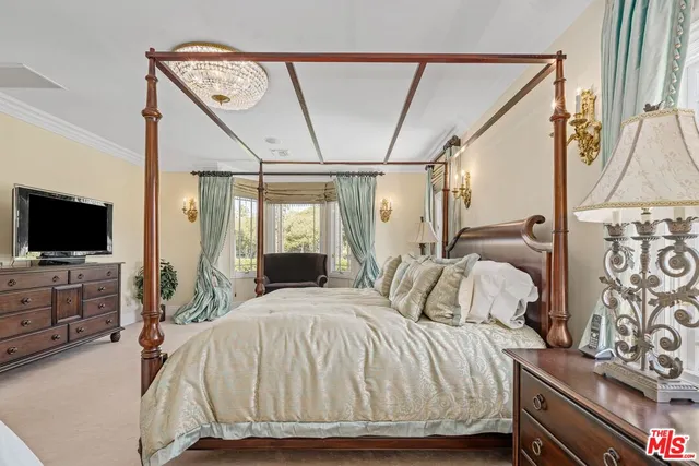 a spacious bedroom with a large tub and shower