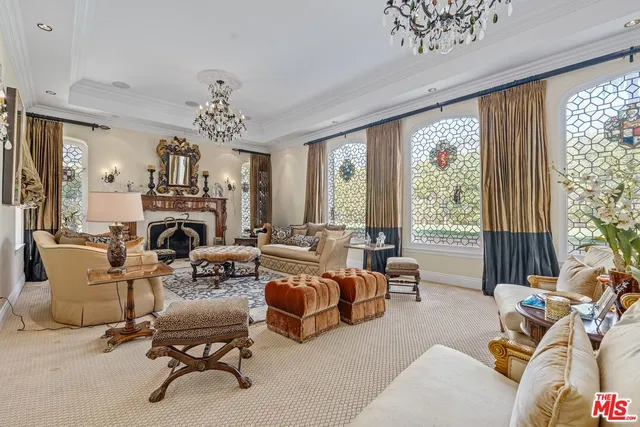 a living room with furniture or chandelier and a fireplace