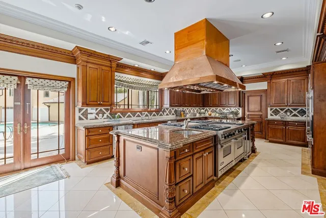 a kitchen with stainless steel appliances granite countertop a stove and a sink