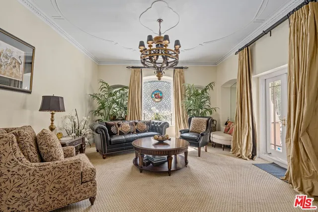 a living room with furniture a chandelier and a chandelier