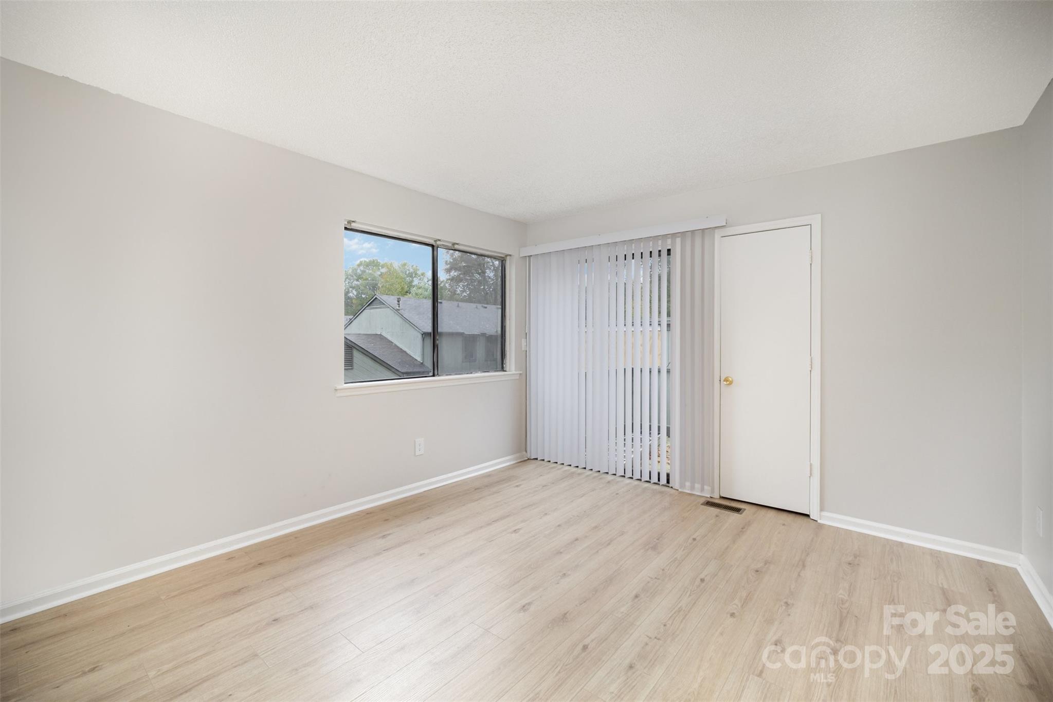 6128 Bent Tree Court Charlotte, NC 28212 - Photo 15 of 16 an empty room with wooden floor and windows