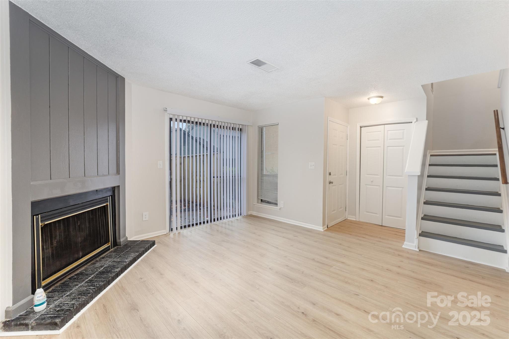 6128 Bent Tree Court Charlotte, NC 28212 - Photo 3 of 16 a view of empty room with wooden floor and fireplace