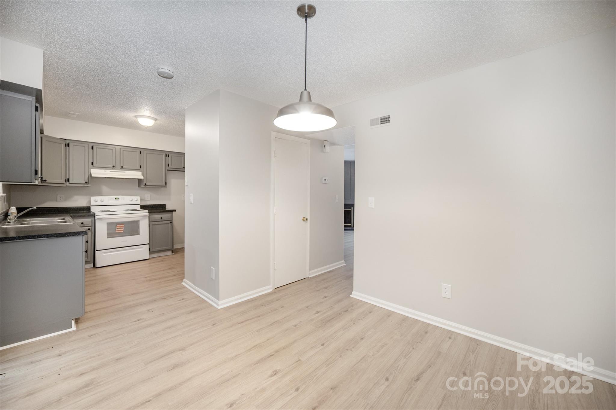 6128 Bent Tree Court Charlotte, NC 28212 - Photo 6 of 16 a kitchen with stainless steel appliances granite countertop a sink a stove a refrigerator and cabinets