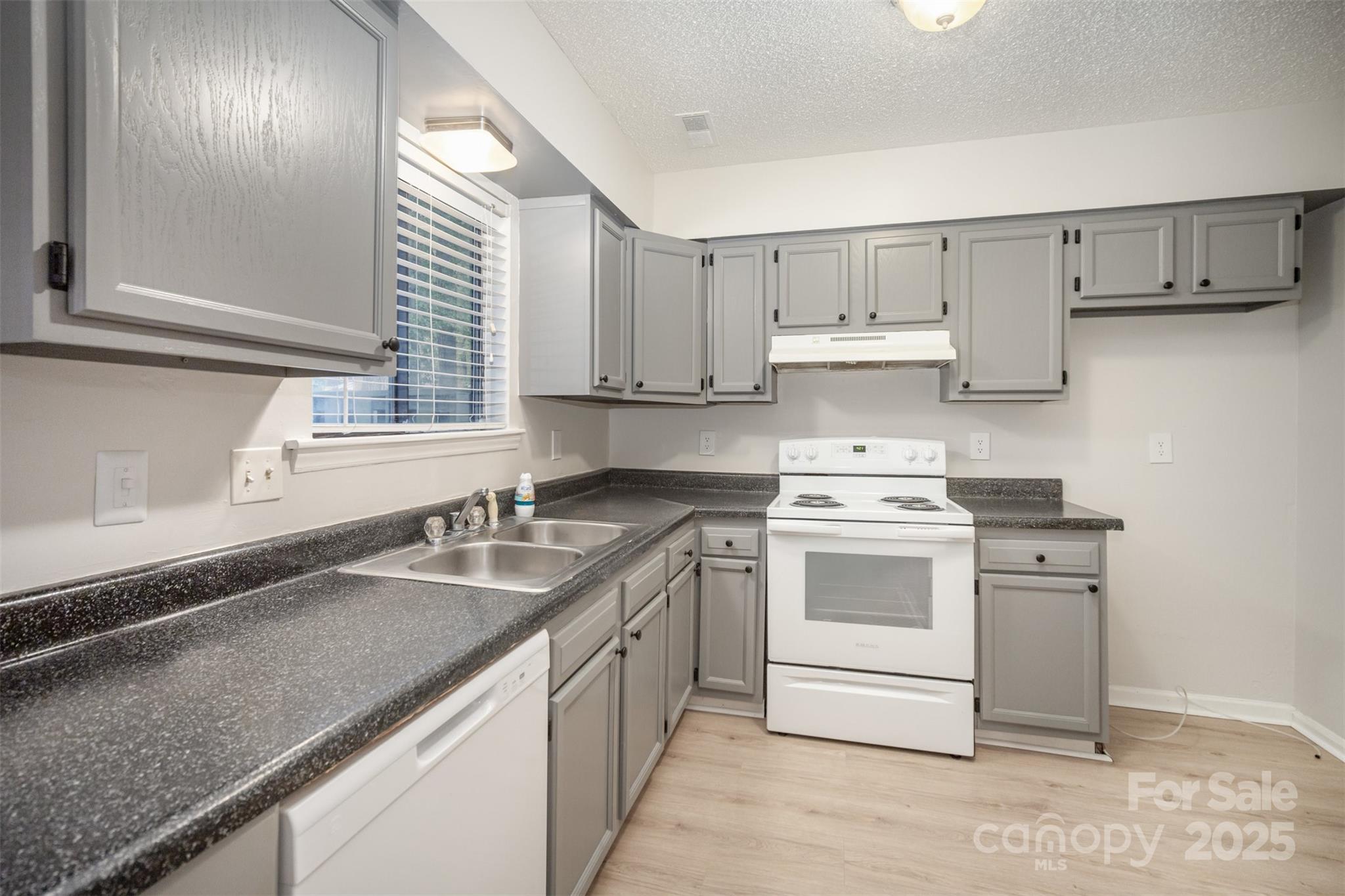 6128 Bent Tree Court Charlotte, NC 28212 - Photo 7 of 16 a kitchen with stainless steel appliances granite countertop a sink stove and cabinets