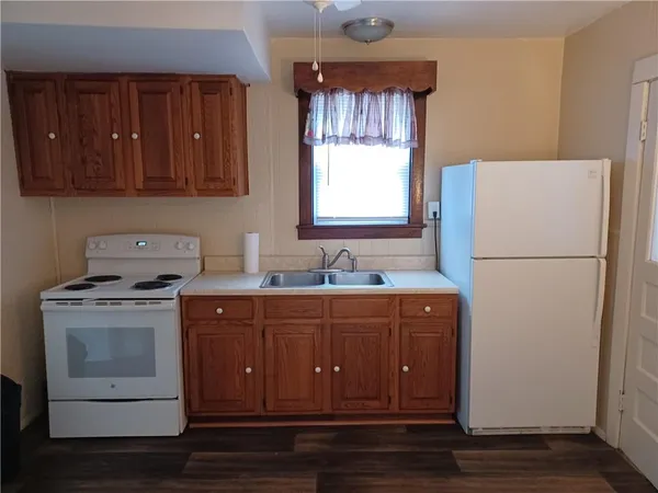 a kitchen with a sink and a refrigerator