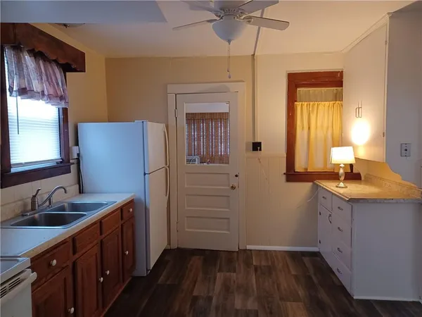 a kitchen with sink cabinets and wooden floor