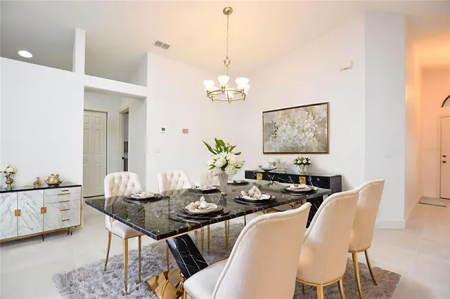 a view of a dining room with furniture and chandelier