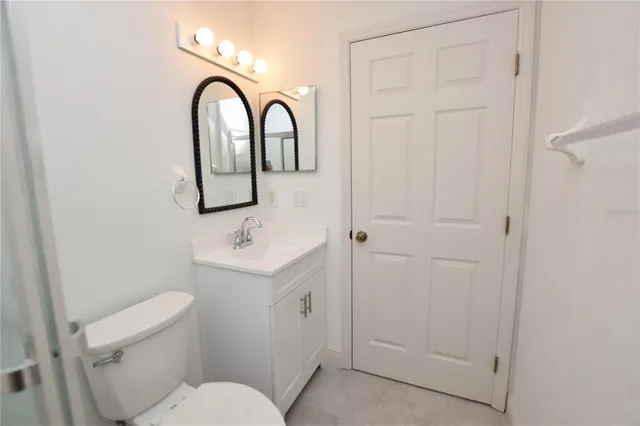 a bathroom with a sink a toilet and a mirror