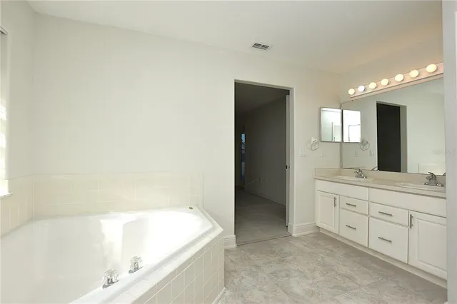 a bathroom with a bathtub and a sink