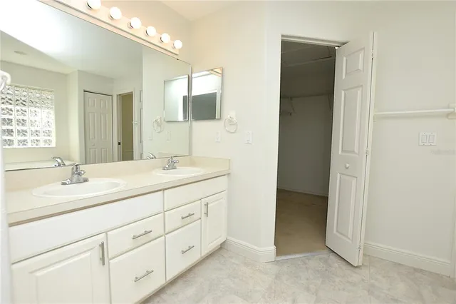 a bathroom with a double vanity sink and mirror