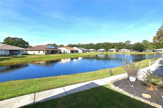 a view of a lake with houses in the back
