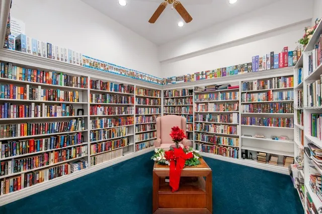 a room with bookshelf and a workspace