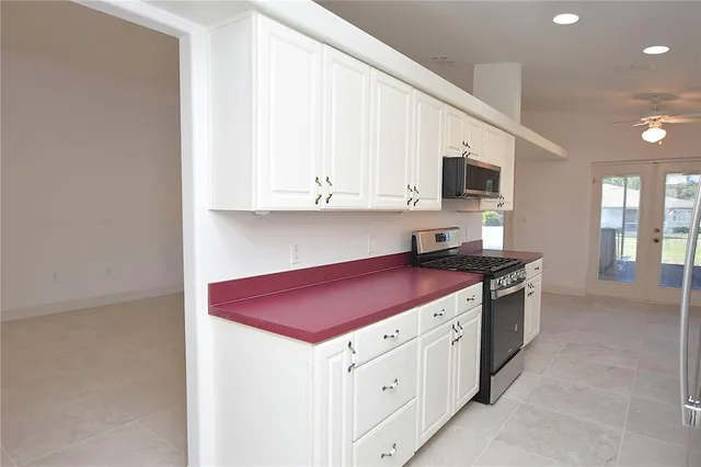 a kitchen with stainless steel appliances granite countertop a sink stove and cabinets