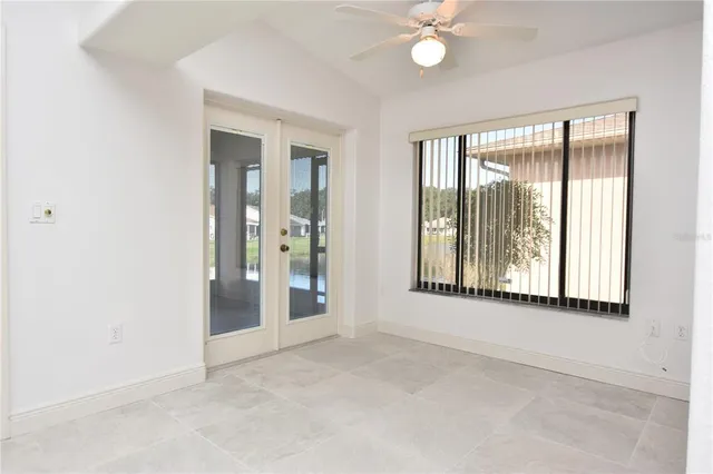 an empty room with windows and closet