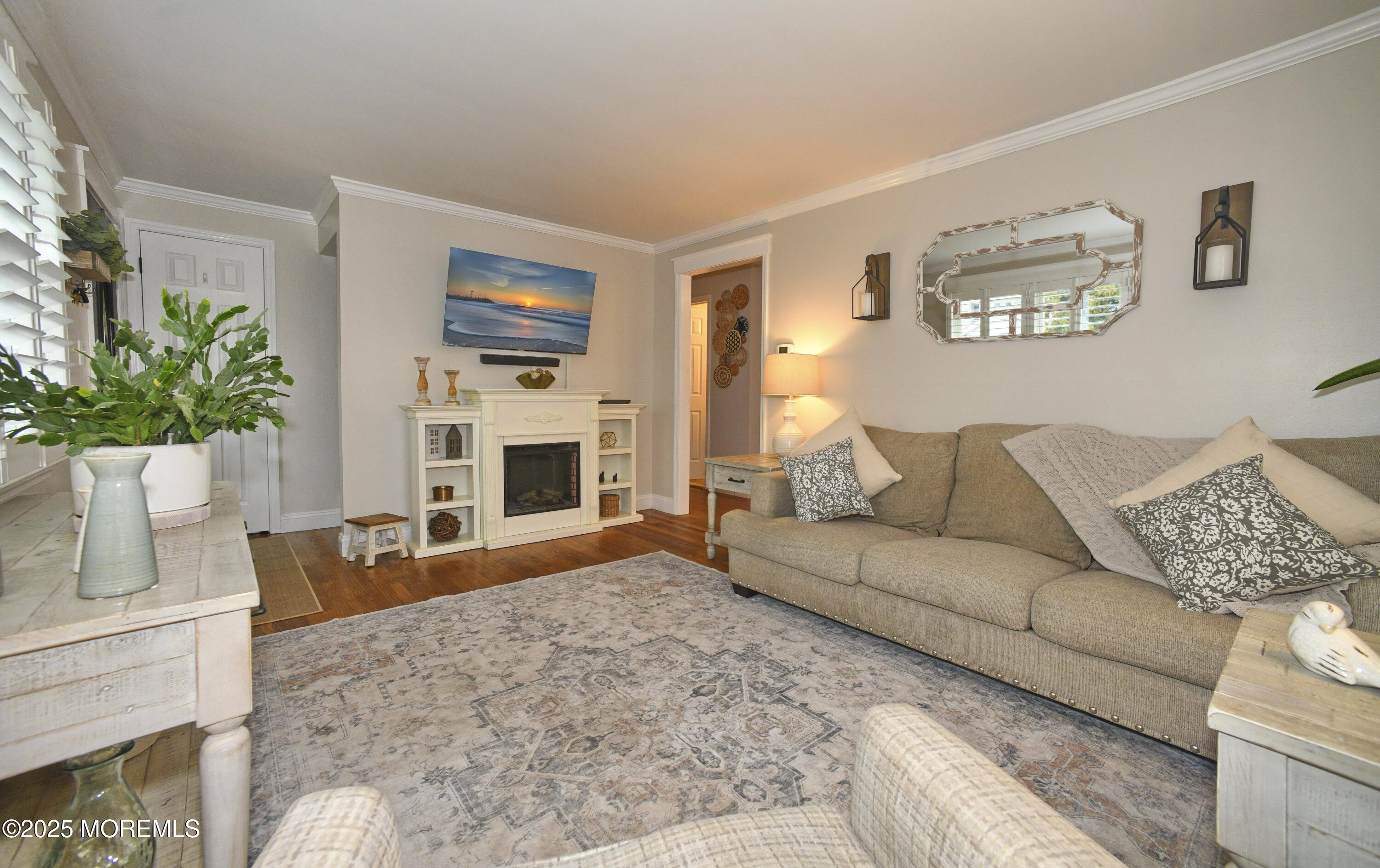 2222 Kenneth Road Point Pleasant, NJ 08742 - Photo 8 of 27 a living room with furniture a fireplace and a potted plant