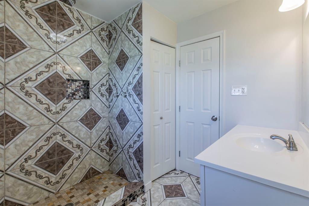 1029 North New Road Waco, TX 76710 - Photo 12 of 26 a bathroom with a sink and shower