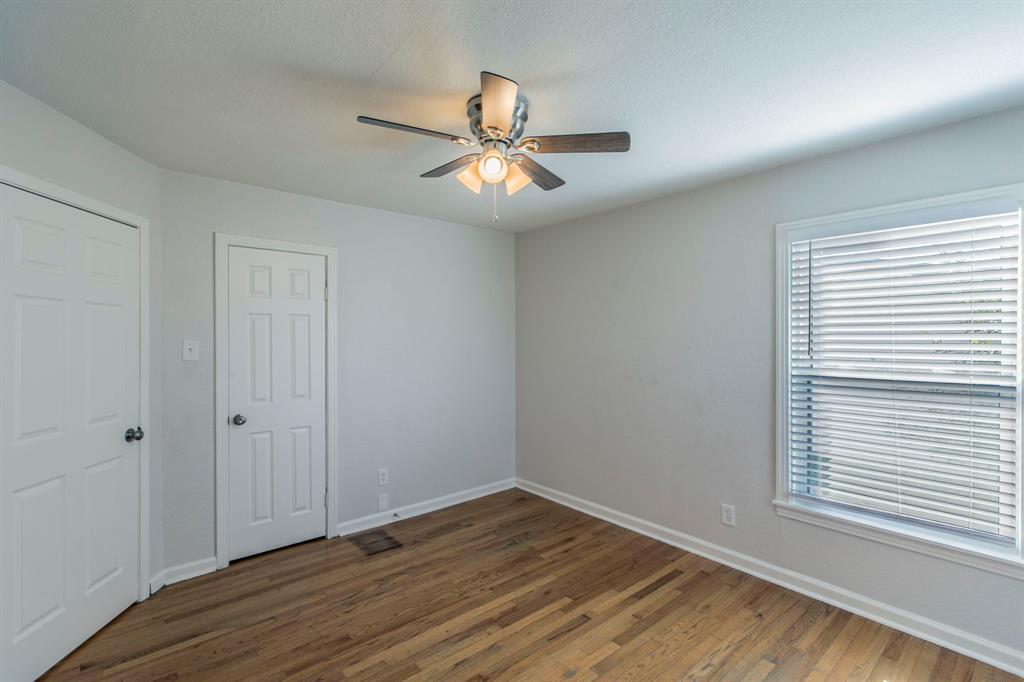 1029 North New Road Waco, TX 76710 - Photo 14 of 26 wooden floor in an empty room with a window