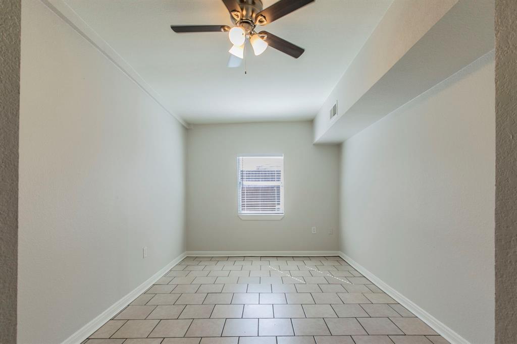 1029 North New Road Waco, TX 76710 - Photo 18 of 26 an empty room with chandelier fan and windows