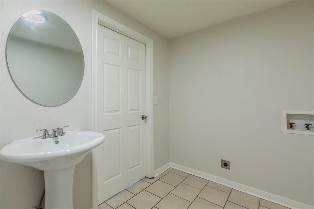 1029 North New Road Waco, TX 76710 - Photo 20 of 26 a bathroom with a sink and a mirror