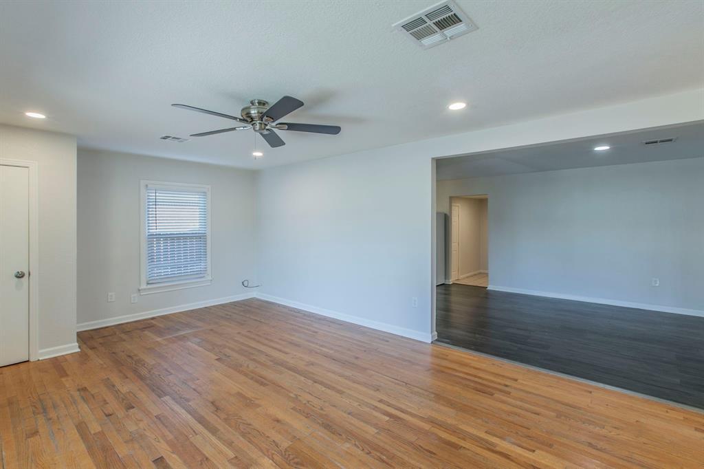 1029 North New Road Waco, TX 76710 - Photo 5 of 26 wooden floor in an empty room with a window