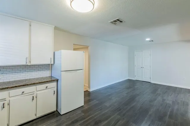 a white refrigerator freezer sitting inside of a kitchen