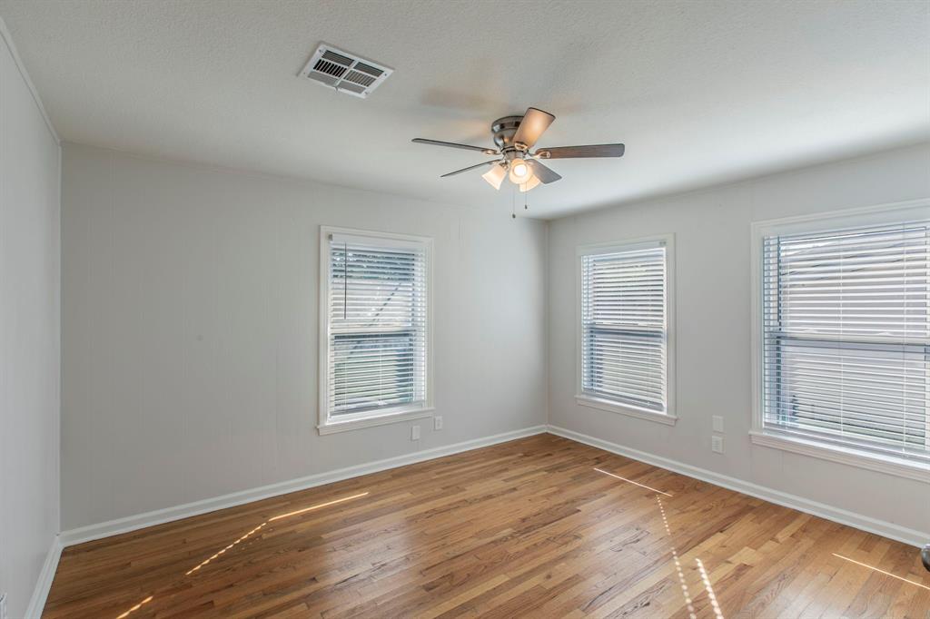 1029 North New Road Waco, TX 76710 - Photo 9 of 26 a view of an empty room with a window and wooden floor